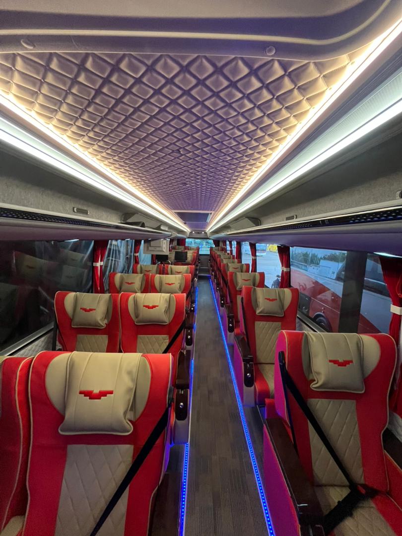 Red/beige VIP cabin front-to-rear with quilted ceiling and aisle LEDs