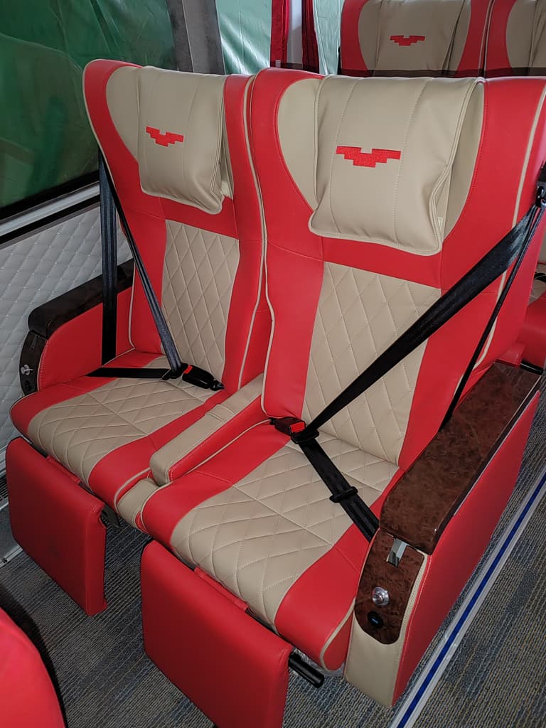 Passenger seat / window detail — red & beige interior