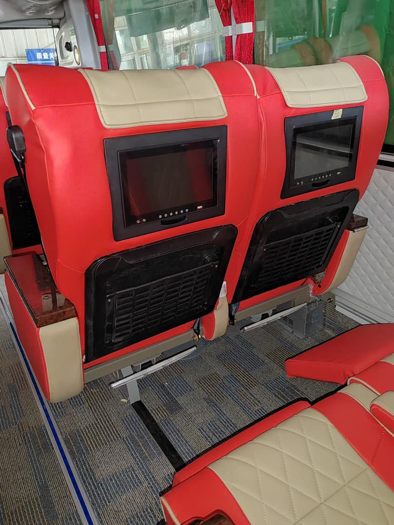 Passenger seat / window detail — red & beige interior