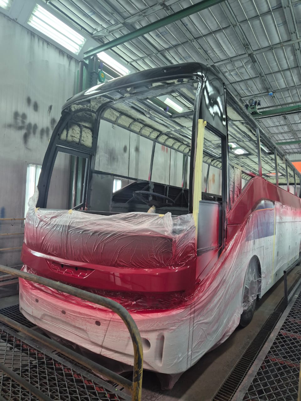 Front shell in paint booth with red and black sections applied